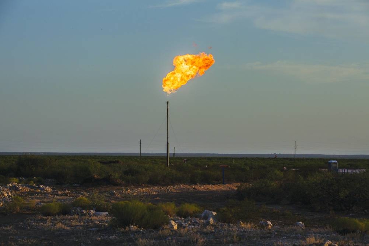 A gas flare near Mentone, Texas. Drillers in the Permian Basin of West Texas and New Mexico have helped make the US the world’s largest oil producer. In the process, they’ve also glutted the region with natural gas, which is extracted there as a byproduct of crude.