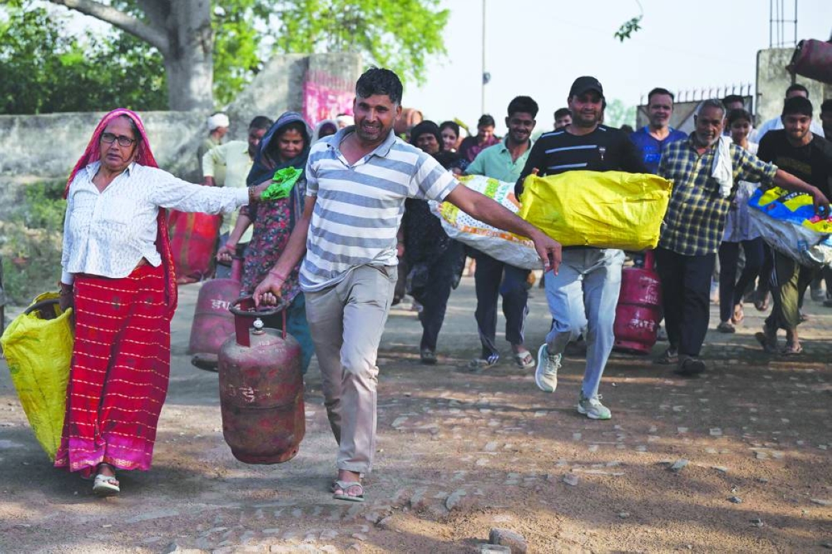 People arriving with empty LPG cylinders for refilling, in a village on the outskirts of Uttar Pradesh's Jewar district. (AFP)