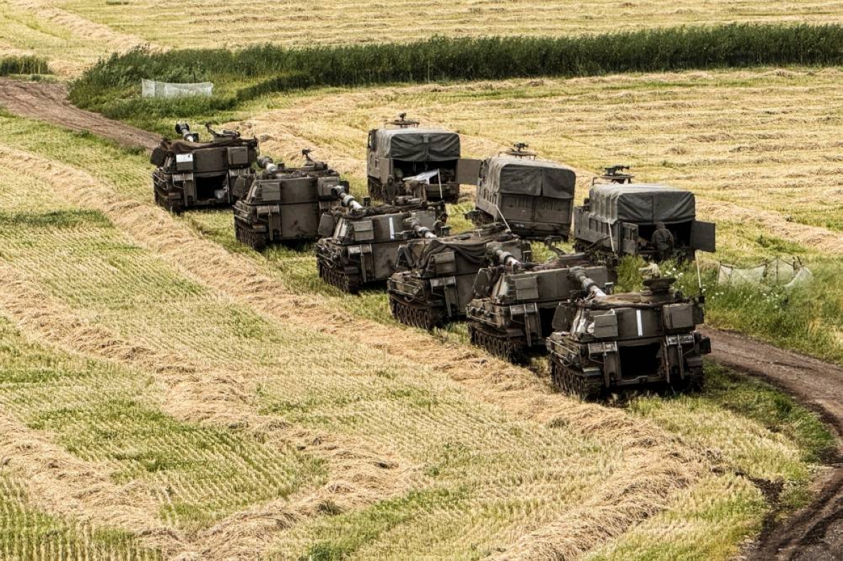 Israeli artillery units and military vehicles in formation on the Israeli side of the Israel-Lebanon border, in northern Israel May 4, 2026. Picture taken with a mobile phone. REUTERS/Avi Ohayon