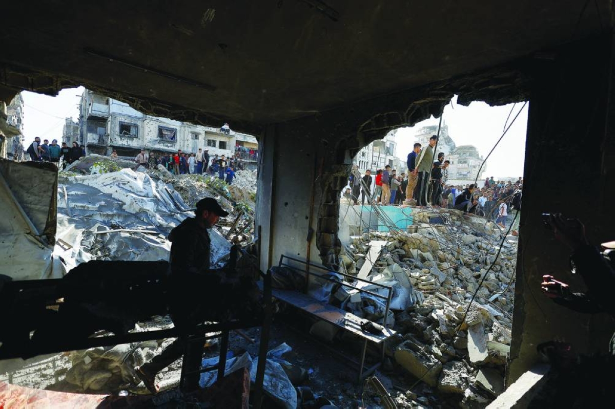 Palestinians inspect the site of an Israeli strike that targeted a police post, in Gaza City, May 5, 2026. REUTERS