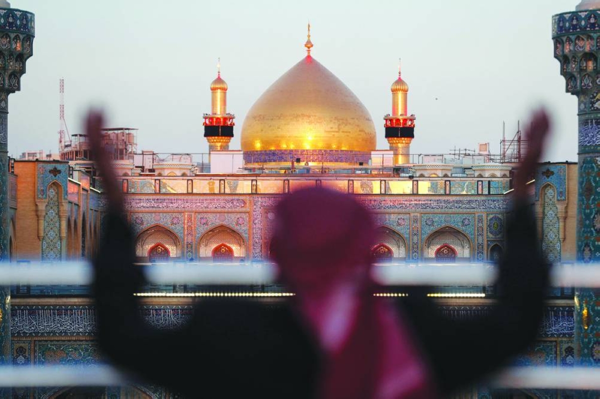 A Shia Muslim man gestures while visiting the Imam Ali Shrine during the fasting month of Ramadan in Najaf on March 10, 2026. (AFP)
