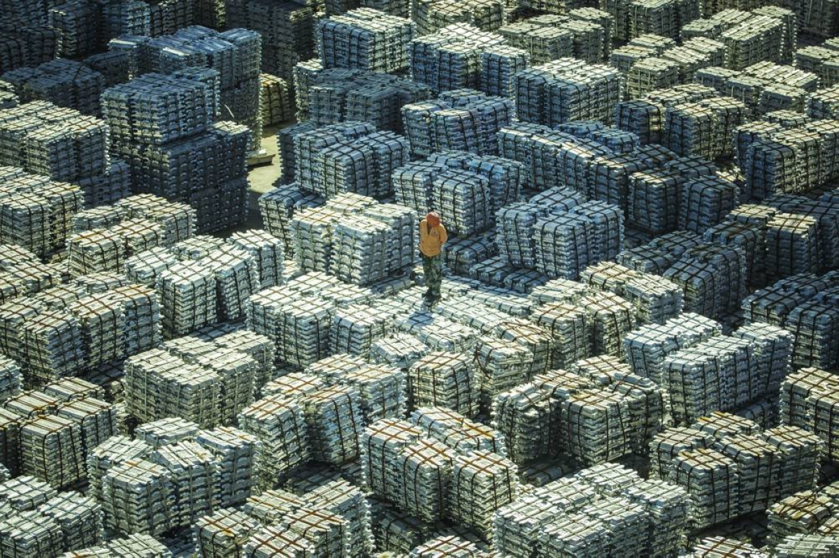 
A worker stands on bundles of aluminium ingots at a China National Materials Storage and Transportation Corp stockyard in Wuxi. Metal exports from China, especially aluminium, are getting a significant lift from the war in the Middle East, which has cut regional supplies while boosting demand for clean-tech products as fossil fuel prices soar. 
