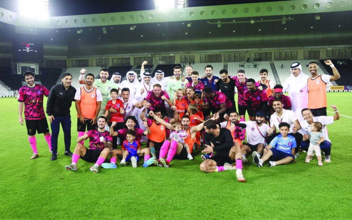 

Al Shahania players celebrate with support staff and their families after winning the Qatar Stars League Play-Off match against Al Kharaitiyat.