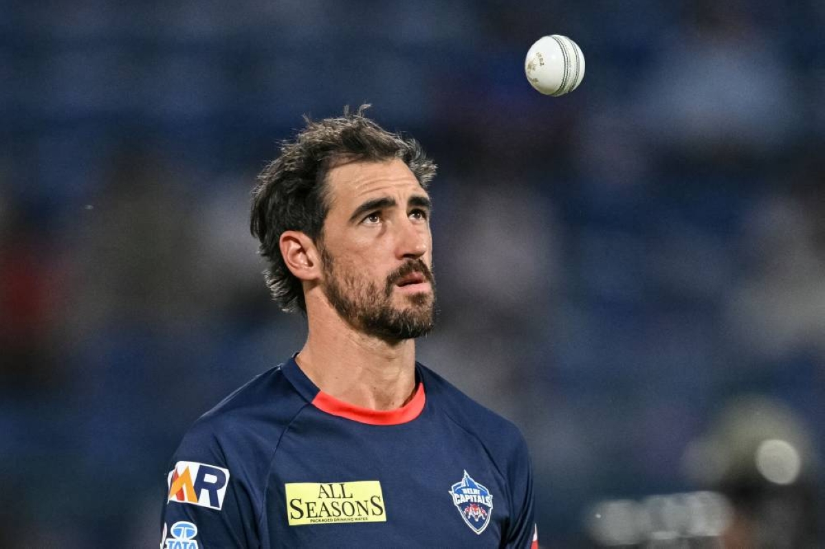 Delhi Capitals' Australian cricket player Mitchell Starc tosses the ball as he warms up before the start of the 2026 Indian Premier League (IPL) T20 match between Delhi Capitals and Kolkata Knight Riders at the Arun Jaitley Stadium in New Delhi on May 8, 2026. (AFP)