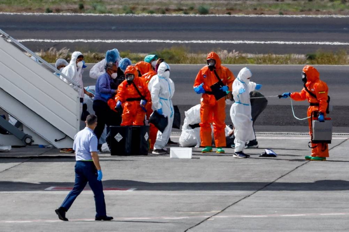 A passenger of the cruise ship MV Hondius, which was affected by a hantavirus outbreak, gets disinfected on the tarmac at Tenerife Sud airport, Canary Islands, yesterday. (Reuters)