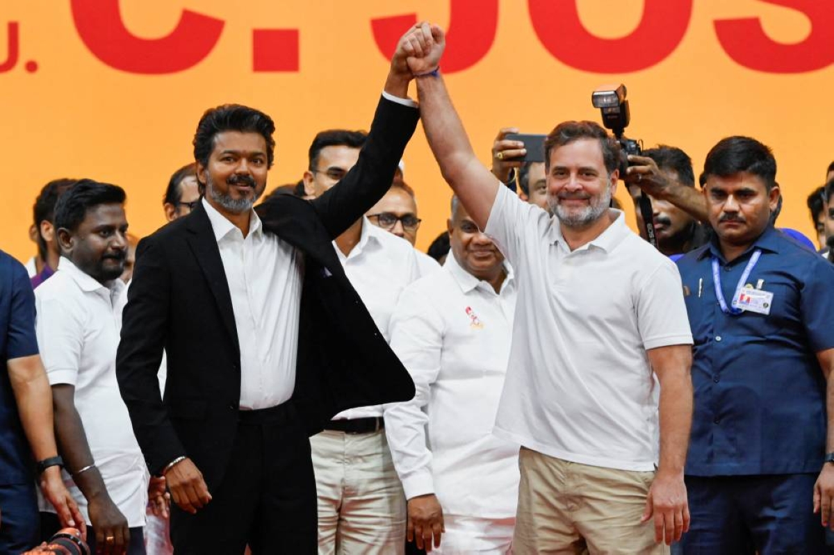 Tamil Nadu Chief Minister C Joseph Vijay (left) holds the hand of Congress leader Rahul Gandhi during a swearing-in ceremony as Chief Minister of Tamil Nadu at Jawaharlal Nehru Stadium, Chennai,yesterday. (Reuters)