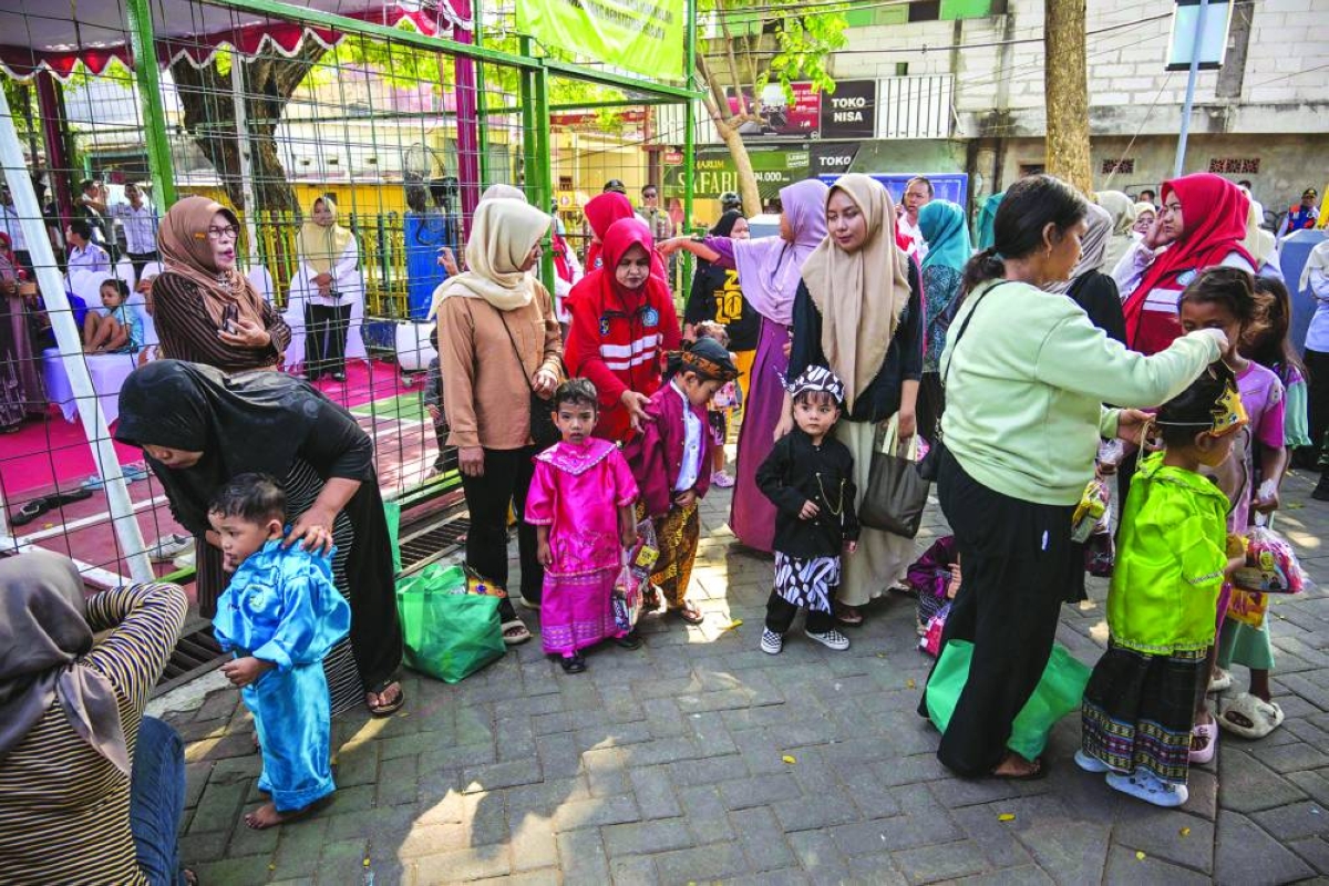 Mothers and their children waiting their turn to receive the measles-rubella vaccine as part of the governments health programme to combat childhood diseases in Surabaya. (AFP)