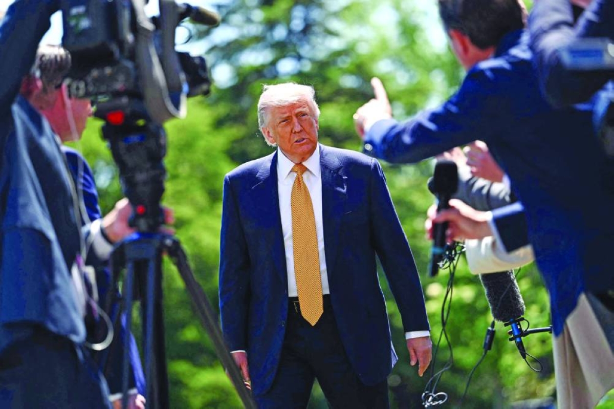
US President Donald Trump speaks to the press before walking to board Marine One as he departs from the South Lawn of the White House in Washington, DC, yesterday. President Trump said he was ready to discuss US arms sales to Taiwan during his visit this week to Beijing, as he suggested his personal chemistry with counterpart Xi Jinping would prevent a Chinese invasion of the island. Trump will bring along top US executives for a trip expected to focus heavily on the US president’s hopes to ramp up trade. (PICTURES: AFP) 