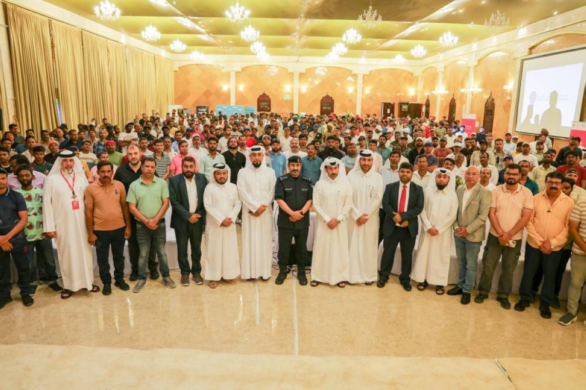 Officers from the Ministry of Interior and officials from Shell Qatar, with workers from companies.