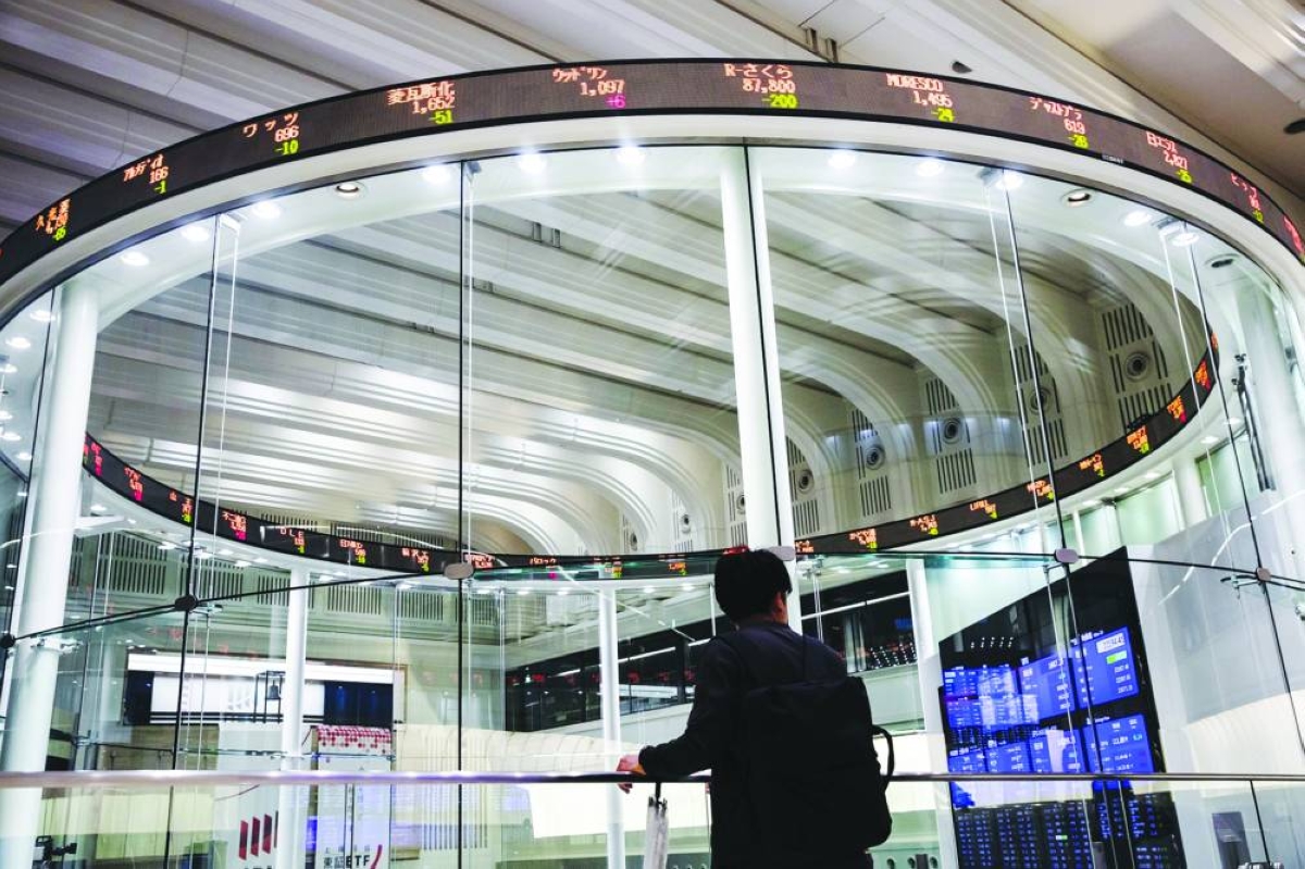 An electronic ticker displays share prices at the Tokyo Stock Exchange. The Nikkei 225 closed up 0.8% to 63,272.11 points Wednesday.