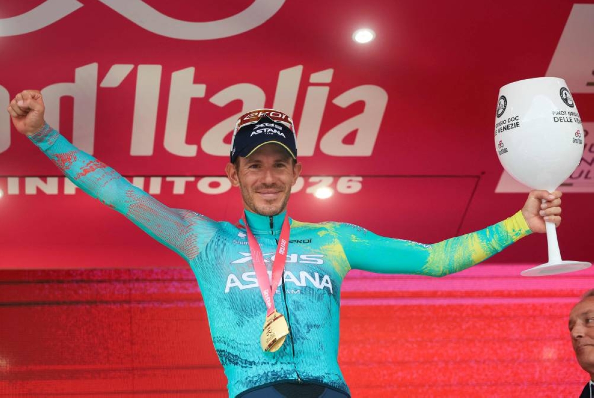 Italian rider Davide Ballerini celebrates on the podium after winning the 6th stage of the Giro d'Italia in Naples, Italy, on May 14, 2026. (AFP)