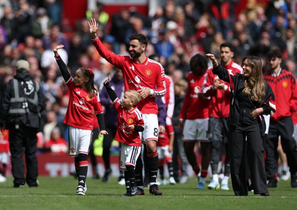 Manchester United's Bruno Fernandes with his wife Ana Pinho and their children Matilde and Goncalo at the end of United's Premier League match against Nottingham Forest at Old Trafford, Manchester. (Reuters)