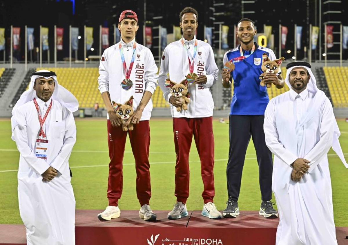 Team Qatar athlete Mubarak Saeed (centre) celebrates winning the gold medal after claiming victory in the men’s 1500m race. Qatar's Zakaria al-Alami secured silver and Kuwait’s Badr Al Suwaid took bronze. Qatar Athletics Federation president Mohammed al-Fadala is also present.