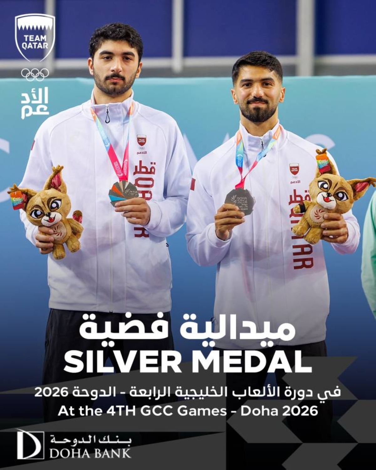 Mohamed Abdulwahab and Abdullah Abdulwahab celebrate after winning the silver in the men's doubles table tennis competitions. 
