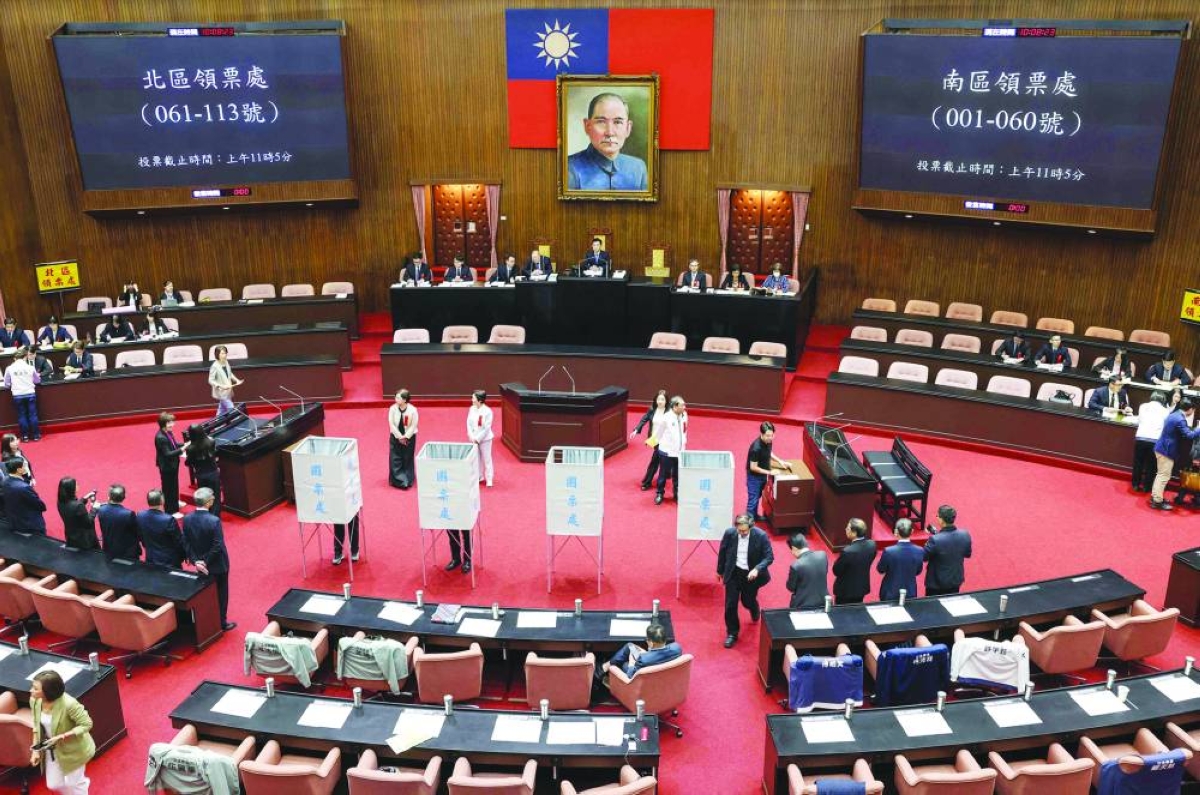 Members of Taiwan's opposition parties 'KMT' and 'Taiwan People's Party' vote on an impeachment motion against President Lai Ching-te at Legislative Yuan chamber in Taipei Tuesday. (AFP)