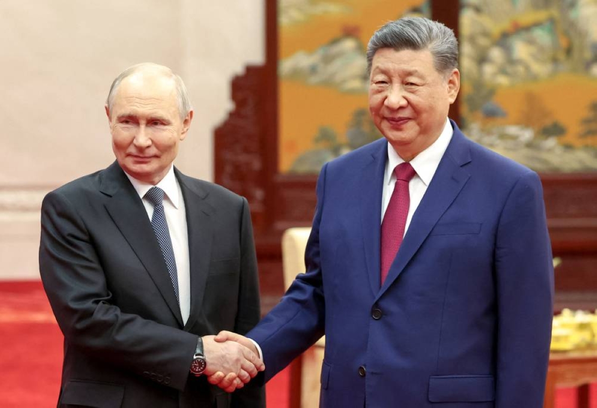 Russian President Vladimir Putin and Chinese President Xi Jinping shake hands as they pose for photos before a tea ceremony following their meeting at the Great Hall of the People in Beijing, China May 20, 2026. Sputnik/Alexander Kazakov/Pool via Reuters ATTENTION EDITORS — THIS IMAGE WAS PROVIDED BY A THIRD PARTY.