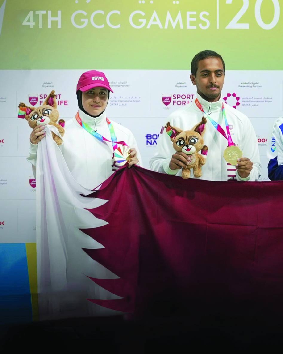 Gold medallists archers Hamad al-Yafei and Aisha al-Saei of Qatar celebrate on the podium of the compound mixed team event on Thursday.