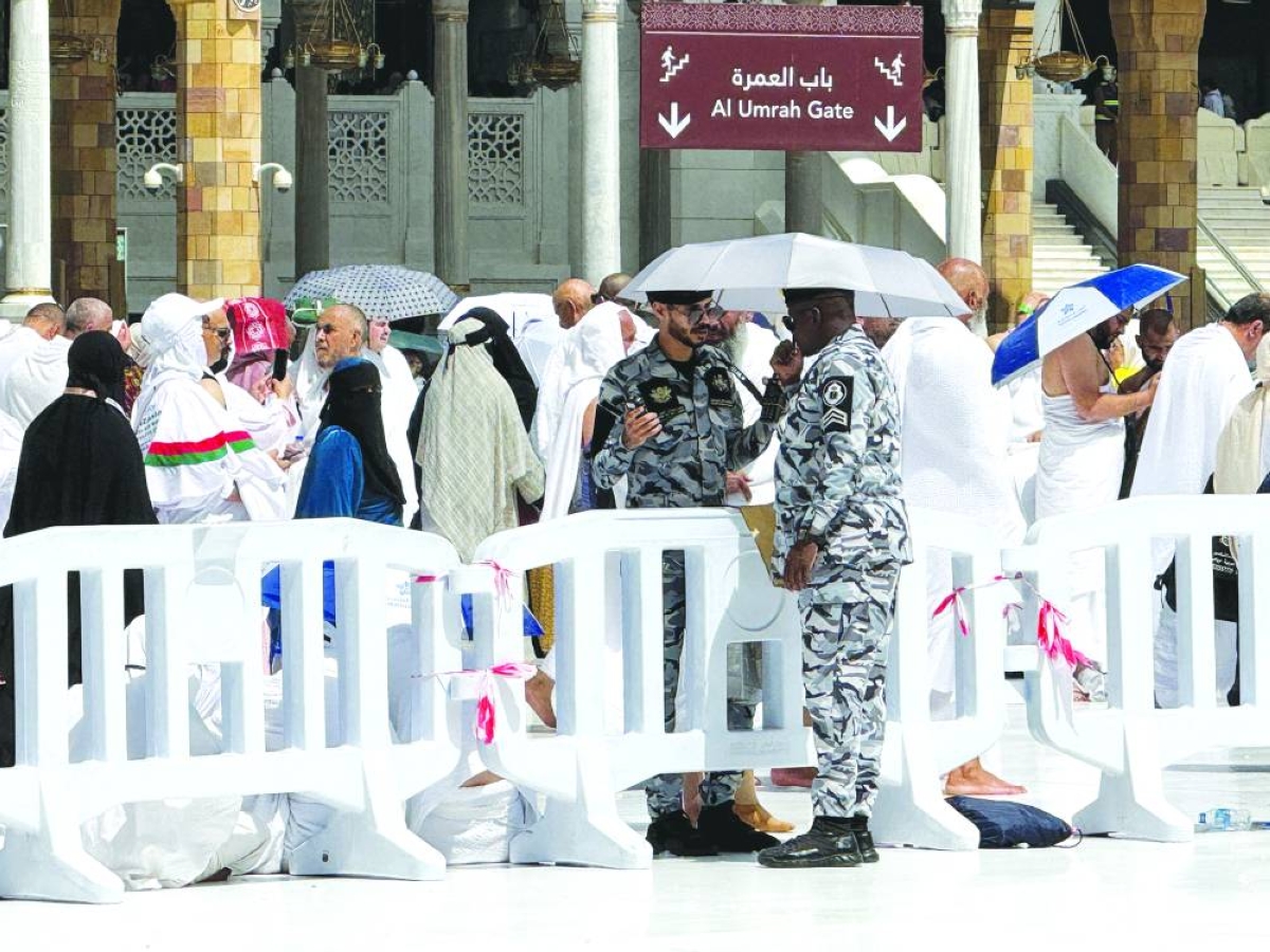 Security personnel speak before the Friday prayers yesterday at the Grand Mosque ahead of the start of Haj in the holy city of Makkah. – Reuters