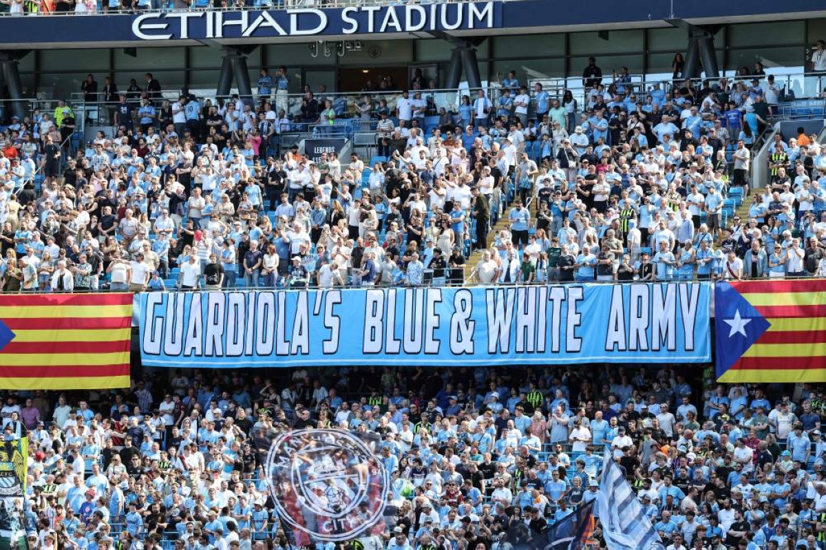 Supporters hold up banners for Manchester City's Spanish manager Pep Guardiola, who leaves the club at the end of the season, during the Premier League match against Aston Villa at the Etihad Stadium in Manchester, north west England. (AFP)