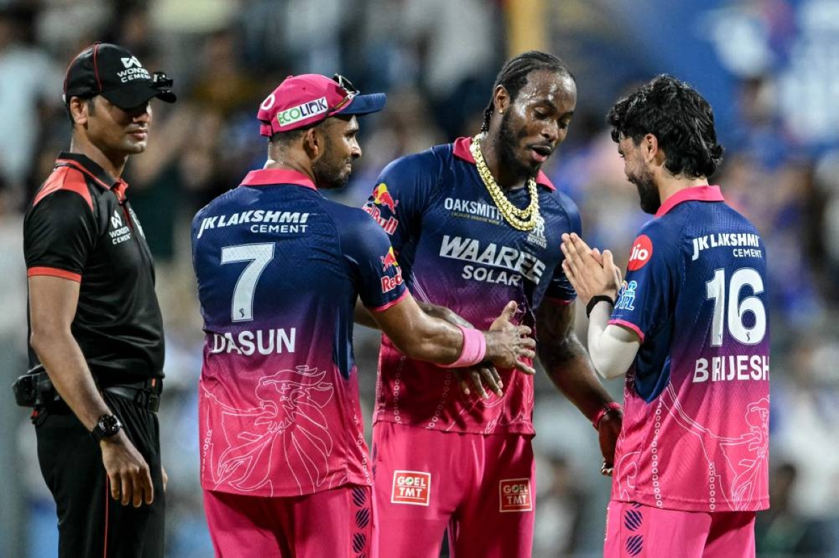 Rajasthan Royals' Brijesh Sharma (right) gestures to teammate English cricket player Jofra Archer (second right) after their team's win at the end of the 2026 Indian Premier League (IPL) T20 match against Mumbai Indians at the Wankhede Stadium in Mumbai on May 24, 2026. (AFP) 