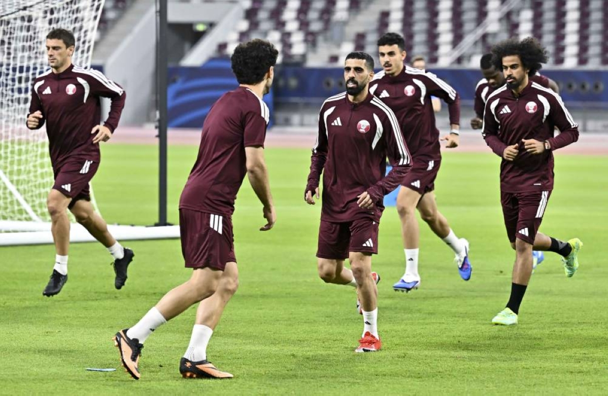 Qatar players Akram Afif (right) and Hasan al-Haydos (centre) with teammates during a training session at the Khalifa International Stadium in Doha on Sunday. 