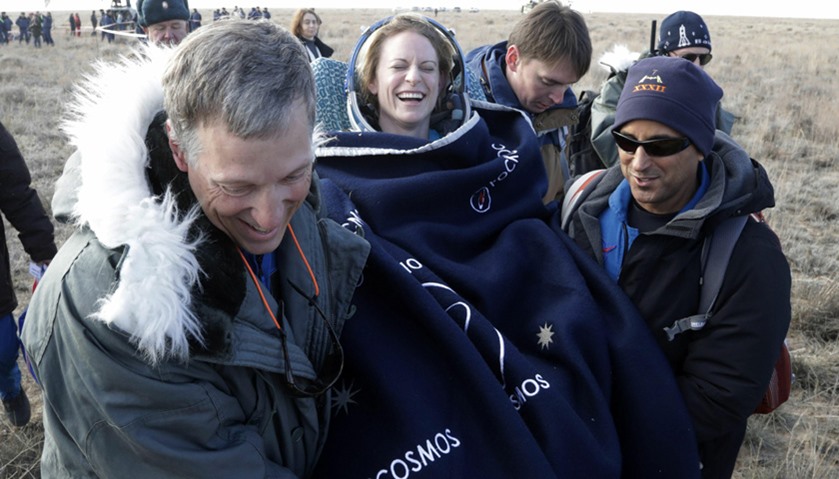Russian space agency rescue team members carry US astronaut Kate Rubins
