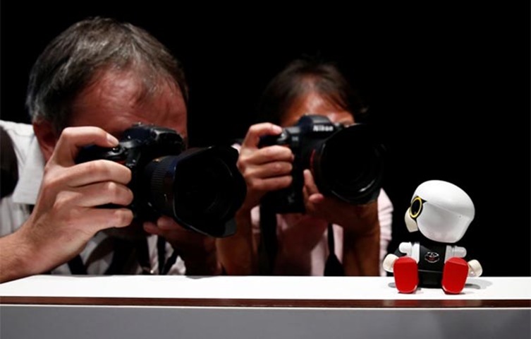 Photographers take pictures of Kirobo Mini during a photo opportunity in Tokyo last week
