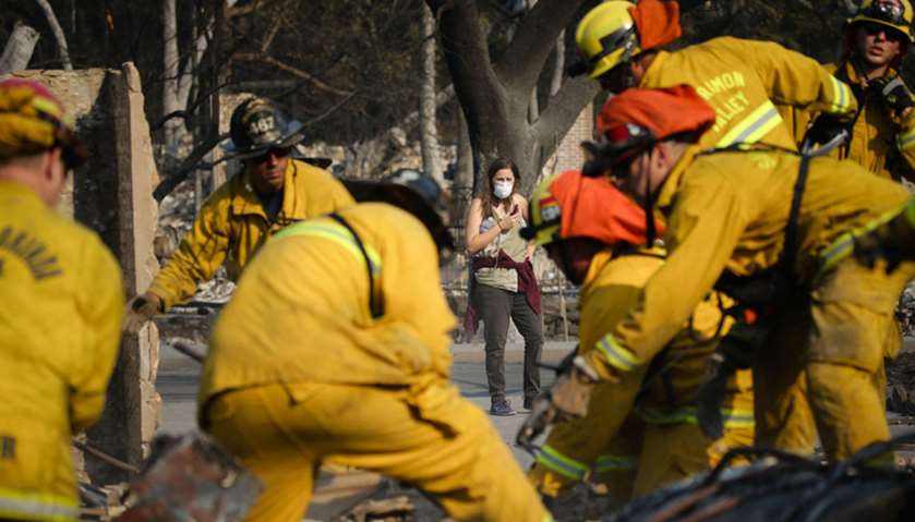 Firefighters search through the remains in Santa Rosa, California
