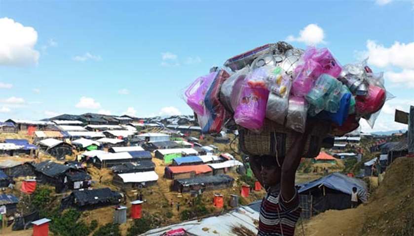 A Bangladeshi vendor sells household plastic items at Balukhali refugee camp