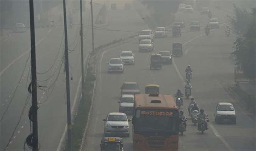 Commuters drive on a smoggy day in New Delhi, a day after the Diwali festival