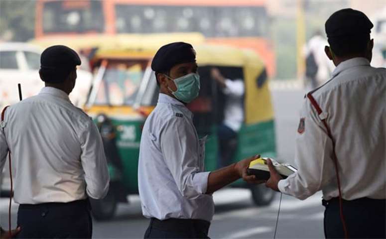 Policemen protect their faces with masks amid heavy smog in New Delhi