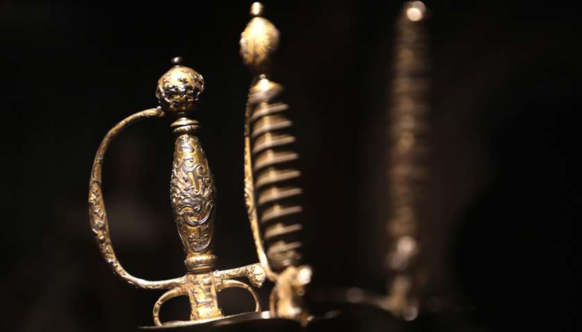 The handles of antique swords on display as part of the \"visiteurs de Versailles\"