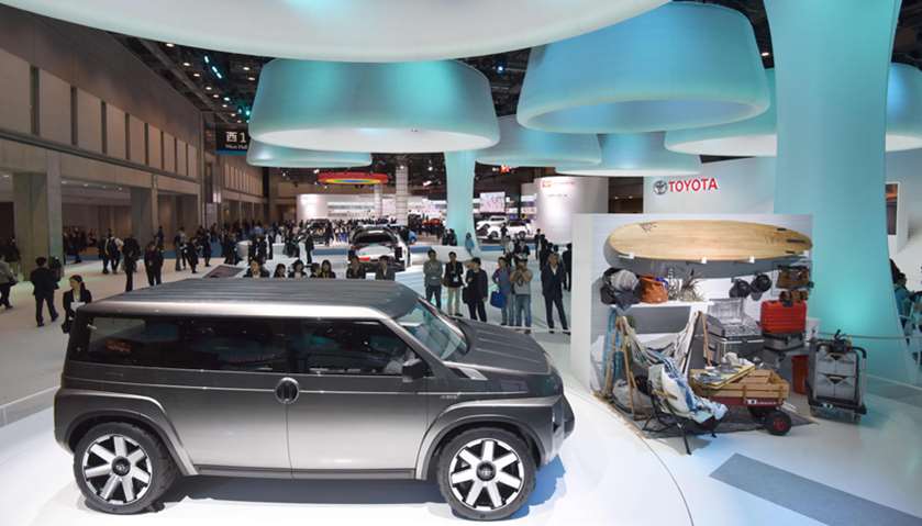 People look at vehicles during the Tokyo Motor Show in Tokyo