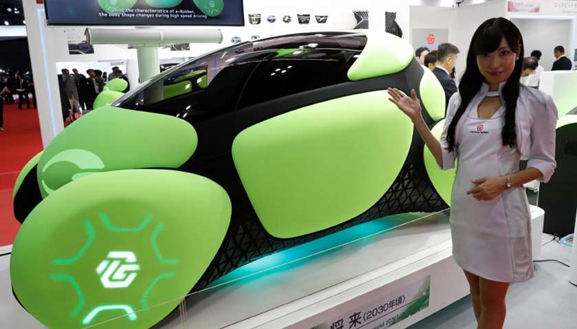 A model presents a one-seater mobility concept car Flesby, exhibited by Japan\'s auto parts maker Toy