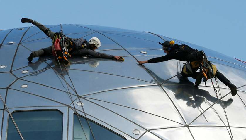 Workers clean one of the nine spheres of the Atomium, a 102-metre-tall (335-feet-tall) structure