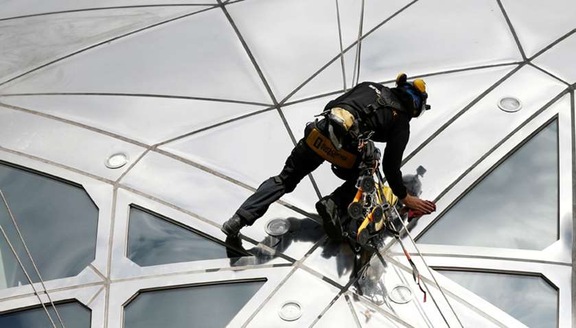 A worker cleans one of the nine spheres of the Atomium, a 102-metre-tall (335-feet-tall) structure
