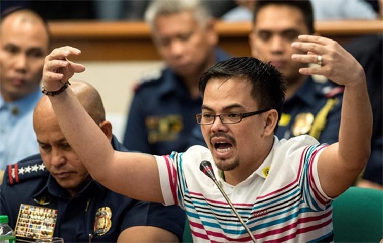 Kerwin Espinosa, son of the late mayor Rolando Espinosa, gestures as he answers senators\' questions
