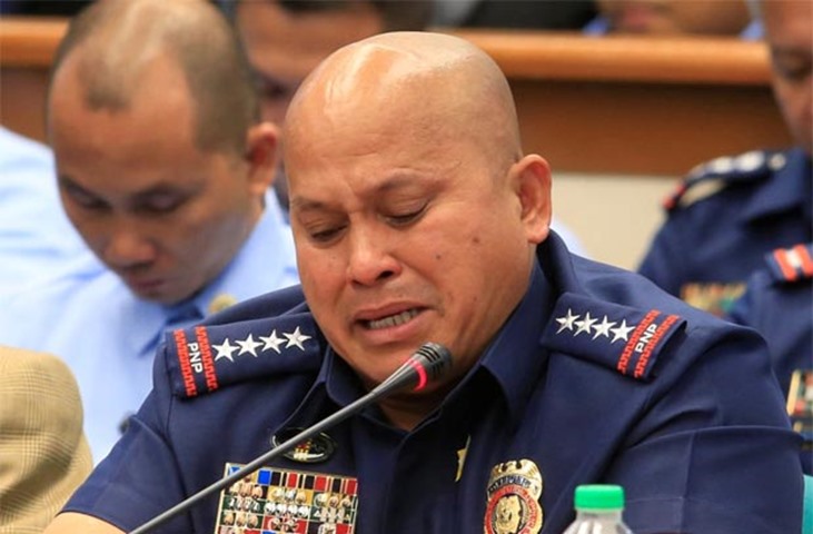 Philippine National Police chief Ronald Dela Rosa cries while answering questions at the hearing