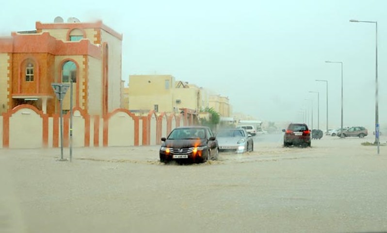 Vehicles wading through a flooded road
