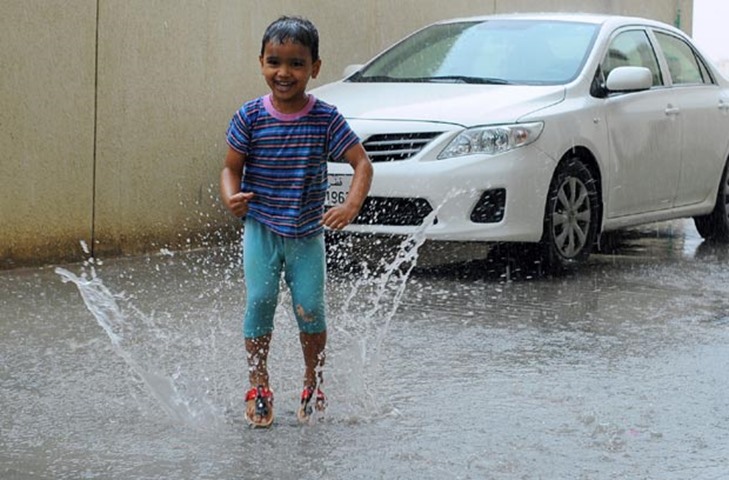 A child soaks up the fun during the rain