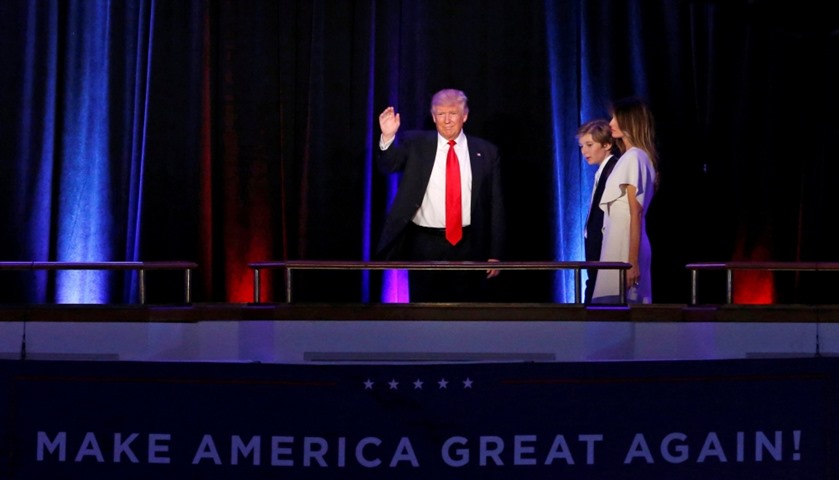 Donald Trump arrives to address supporters with his son Barron and wife Melania