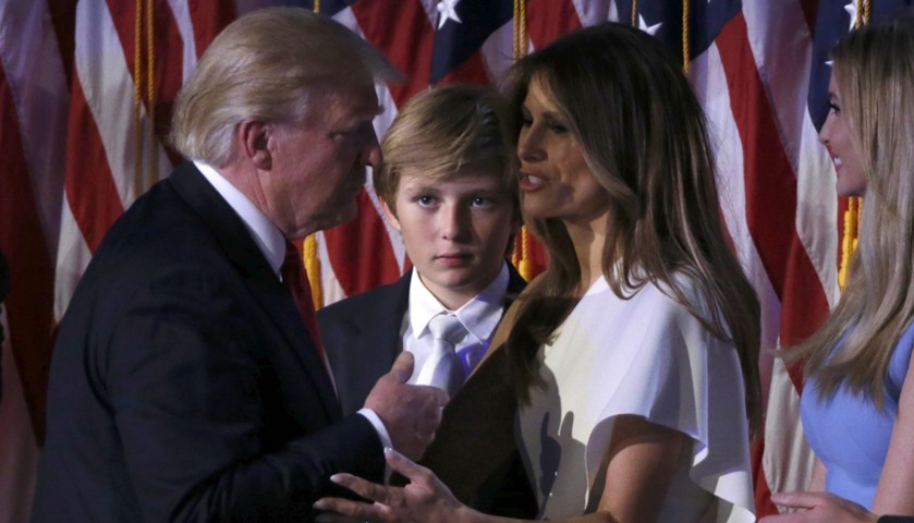 Donald Trump talks with his son Barron (C), his wife Melania (2nd R) and his daughter Ivanka (R)