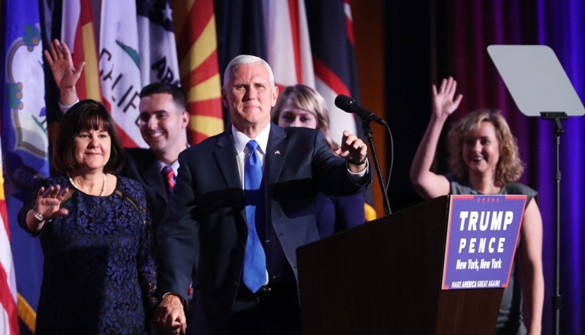Vice president-elect Mike Pence walks on stage along with members of his family
