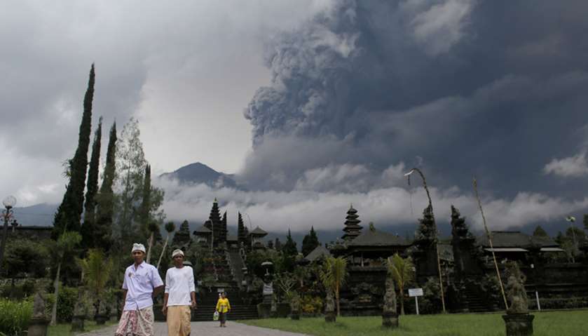 Balinese  walk near Besakih Temple in Karangasem as Mount Agung volcano erupts