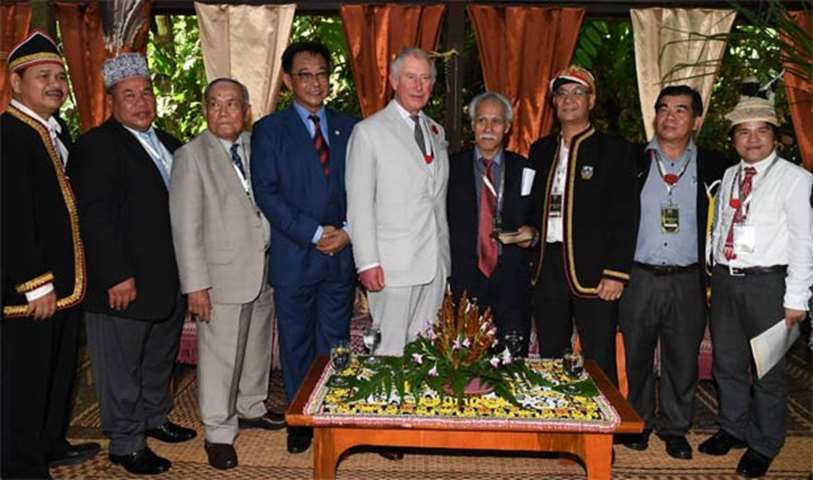 Prince Charles poses for pictures with the heads of tribes at the Sarawak Cultural Village