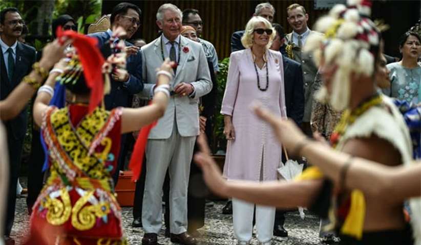 Prince Charles and Camilla, greeted by traditional dancers, are on a seven-day visit to Malaysia