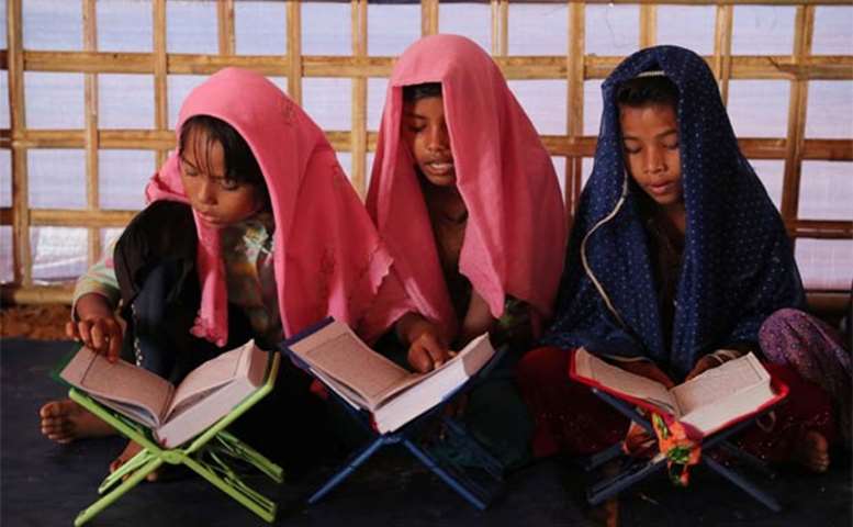 Young Rohingya refugees learn to recite the Holy Qur’an at an Arabic school in Cox\'s Bazar