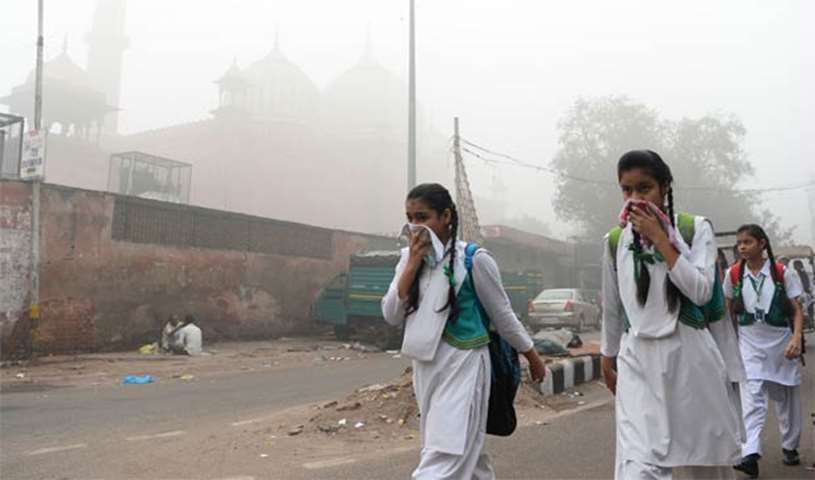 Schoolchildren cover their faces as they walk to school amid heavy smog in New Delhi