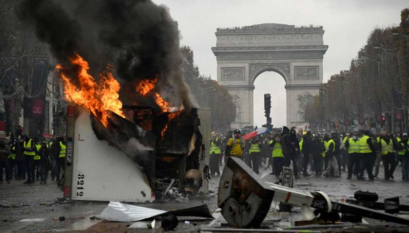 A truck burns during a protest of Yellow vests near the Arc of Triomphe in Paris