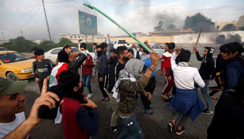 Protesters shout slogans during ongoing anti-government protests in Basra, Iraq
